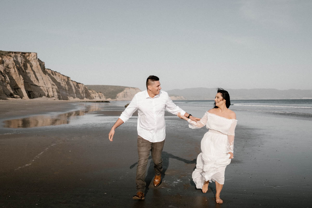 point reyes engagement session playing on the beach