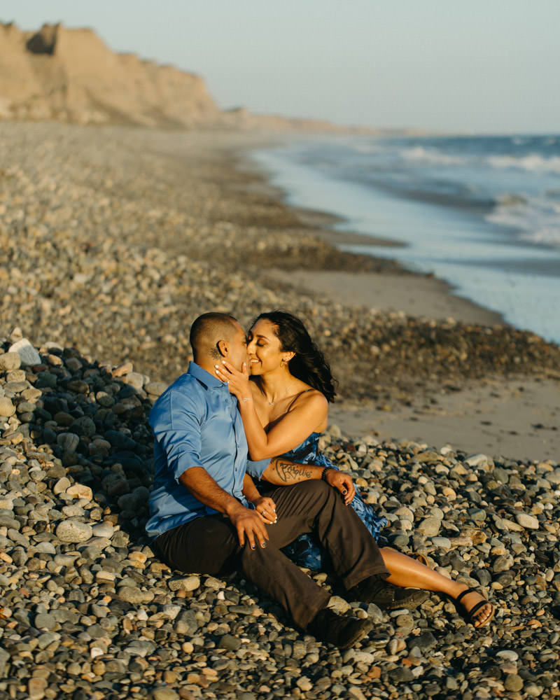 san clemente engagement photos couple sitting on gravels